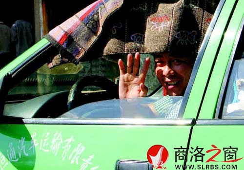 看到記者采訪，旁邊的出租車司機熱心地打了個招呼。
